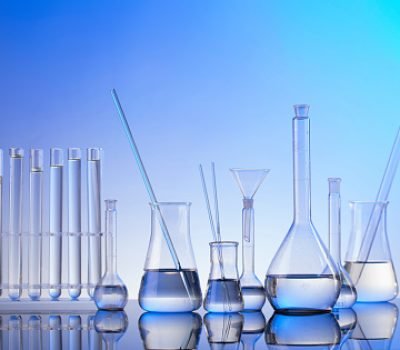Glass tubes and beakers on blue background.